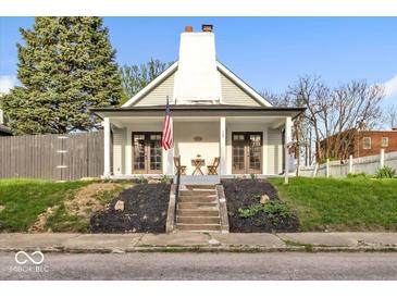 Charming home featuring a welcoming front porch and a well-maintained yard at 15 N Campbell Ave, Indianapolis, IN 46219