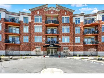 Stunning exterior of a brick condominium building with balconies and well-maintained landscaping at 20971 Shoreline Ct # 306, Noblesville, IN 46062