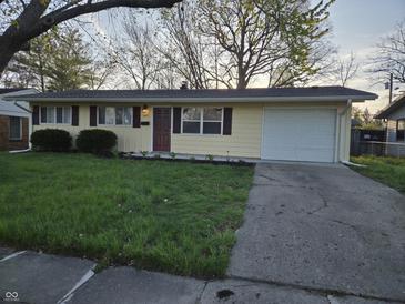 Charming ranch-style home with a well-maintained lawn and attached one car garage at 2465 N Eaton Ave, Indianapolis, IN 46219