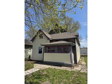 Charming home with siding and porch needing some TLC, surrounded by a lush green yard at 325 Harlan St, Indianapolis, IN 46201