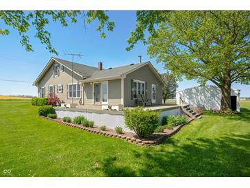 Charming home featuring a welcoming deck and lush landscaping at 403 N Red Gold Dr, Trafalgar, IN 46181