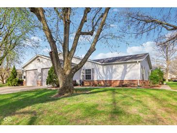 Charming single-story home with a well-maintained lawn and mature tree at 4708 Dorkin Ct, Indianapolis, IN 46254