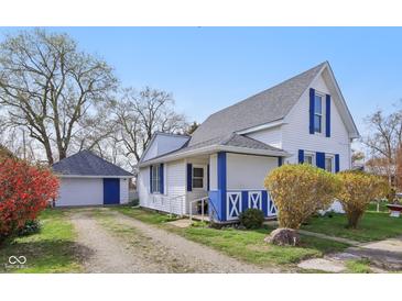 Charming home with blue shutters, a detached garage, and a well-maintained yard at 540 S Broadway St, Atlanta, IN 46031