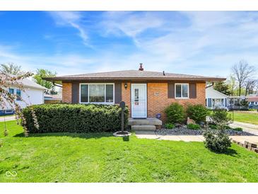 Charming brick ranch with tidy landscaping and a well-manicured front yard at 1043 E Castle Ave, Indianapolis, IN 46227