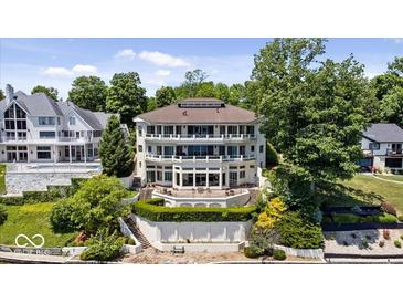 Impressive multi-level home with lake views and manicured landscaping at 10919 Brigantine Dr, Indianapolis, IN 46256