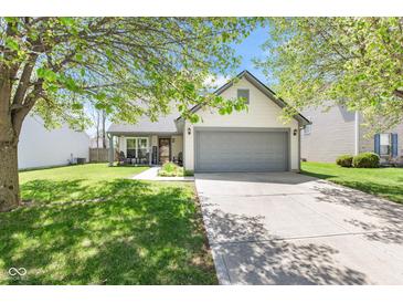 Charming single-Gathering home featuring a well-maintained lawn, a two-car garage, and inviting curb appeal at 11651 Beardsley Way, Fishers, IN 46038