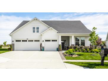 Charming two-story home featuring a three-car garage, complemented by a well-manicured lawn and lush landscaping at 1242 Petit Verdot Dr, Westfield, IN 46074