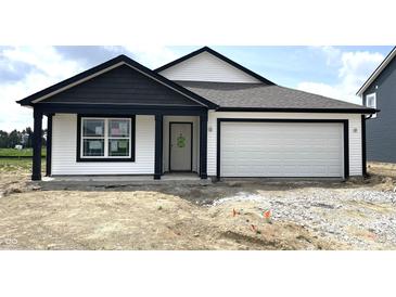Charming single-story home featuring white siding, a two-car garage and contrasting black trim at 1319 Fleming Dr, Greenfield, IN 46140