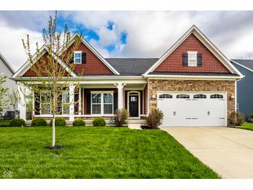 Charming single-Gathering home featuring a stone facade, two-car garage, and a well-manicured front lawn at 15144 Bentfield Ct, Fishers, IN 46037