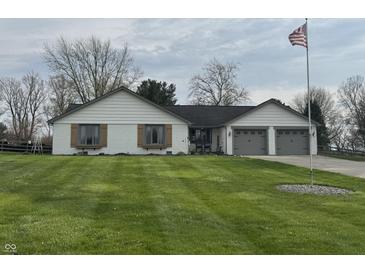 Charming home with lush green lawn, brick accents, and attached two-car garage at 1873 W 950 S, Pendleton, IN 46064