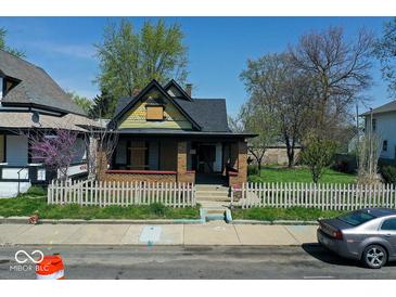 Charming home featuring a cozy front porch and classic architectural details at 3320 E New York St, Indianapolis, IN 46201