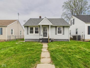 Charming bungalow featuring a well-manicured lawn and a welcoming walkway at 3826 Delaware St, Anderson, IN 46013