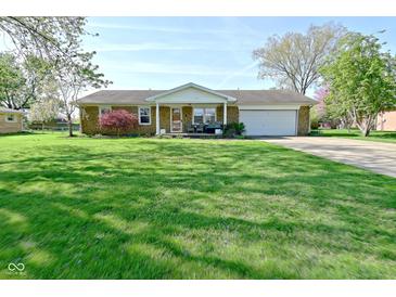 Charming brick ranch-style home with well-manicured lawn and attached one car garage at 5693 W Walnut St, Greenwood, IN 46142