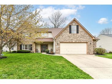 Charming two-story home featuring a brick facade, well-maintained lawn, and attached two-car garage at 693 Prince Dr, Greenwood, IN 46142