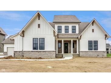 Stunning two-story home with white siding, striking black windows and attractive gray brick foundation at 8092 Abington Way, Zionsville, IN 46077