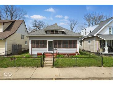 Charming single-story home with a cozy screened-in porch and well-maintained front yard at 1114 N Mount St, Indianapolis, IN 46222