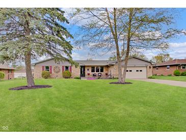 Charming brick ranch home with a well-manicured lawn and attached one car garage at 120 Crosby Dr, Indianapolis, IN 46227