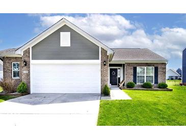 Charming home featuring a two-car garage, brick accents, neat lawn, and a welcoming entrance at 1239 Northcraft Ct, Franklin, IN 46131