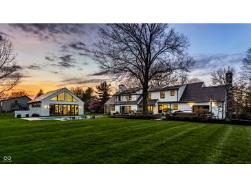 Backyard features a pool, poolhouse, and meticulous landscaping offering a serene outdoor experience at 1995 W 116Th St, Carmel, IN 46032