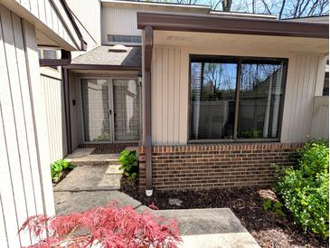 Charming front entrance with a brick accent and a storm door at 21 Osage Ct, Columbus, IN 47201
