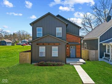 Charming two-story home with gray siding, wood accents, and a well-manicured lawn at 2325 E Brookside Ave, Indianapolis, IN 46218