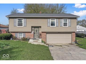 Charming two-story home featuring neutral siding, grey shutters and a two-car garage at 3432 Joan Pl, Indianapolis, IN 46226