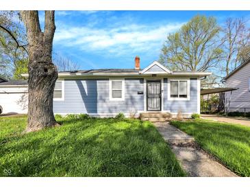 Charming single-story home with light blue siding, a mature tree, and a well-maintained lawn at 3538 Cecil Ave, Indianapolis, IN 46226