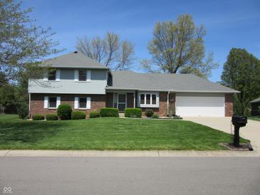 Charming two-story home with brick facade, attached garage, and well-manicured front yard at 4166 Cobblestone Way, Greenwood, IN 46143