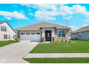 Charming single-story home with a well-manicured lawn and attached two car garage at 5218 Pinehurst Ct, Whitestown, IN 46075