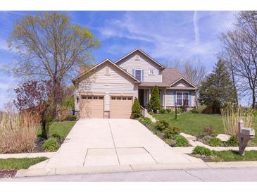 Two-story home featuring an attached two car garage and a concrete driveway at 5251 Ladywood Bluff Pl, Indianapolis, IN 46226