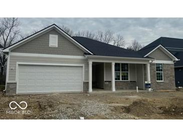 Charming single-story home with a two-car garage and covered front porch at 6474 Ambassador Dr, Plainfield, IN 46168