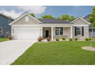 Charming single-story home featuring a manicured lawn, attached garage, and a welcoming front porch at 6474 Ambassador Dr, Plainfield, IN 46168