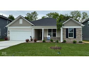 Charming single-story home featuring stone accents, a two-car garage, and a well-manicured front lawn at 6474 Ambassador Dr, Plainfield, IN 46168