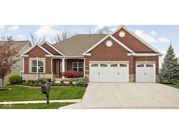 Charming brick home with a well-manicured lawn and a two-car garage, showcasing curb appeal at 7450 Cassilly Ct, Indianapolis, IN 46278