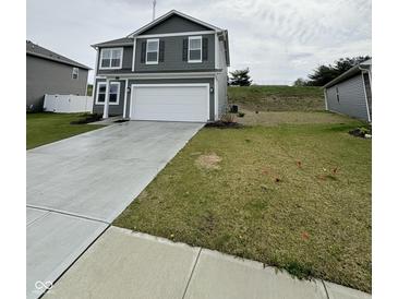 Charming two-story home with gray siding, white trim, and an attached two-car garage at 10931 N Longbranch St, Monrovia, IN 46157