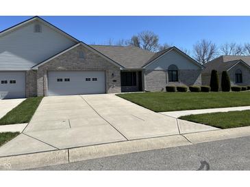 Charming single-story home with attached garage, well-maintained lawn, and long concrete driveway at 160 Bay Ridge Dr, Pendleton, IN 46064