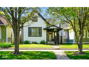 Charming two-story home with a well-maintained lawn and inviting front porch at 1917 Fletcher Ave, Indianapolis, IN 46203