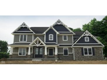 Beautiful two-story home with striking architectural details and a combination of stone and siding at 5179 Oak Ridge Trl, Columbus, IN 47201
