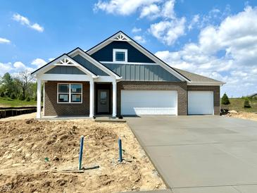 New brick home featuring a two-car garage, craftsman details and a blue-grey color scheme at 5924 Trichel Dr, Greenwood, IN 46143