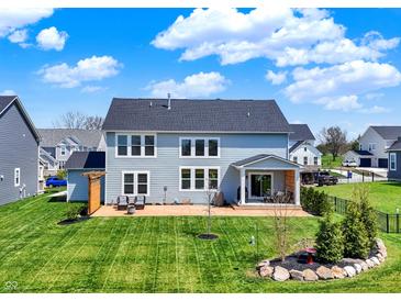 Spacious backyard featuring a well-maintained lawn and a cozy patio area at 16683 Alex Dr, Noblesville, IN 46060