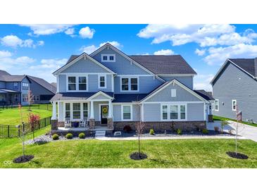Charming two-story home featuring a covered front porch and well-manicured lawn at 16683 Alex Dr, Noblesville, IN 46060