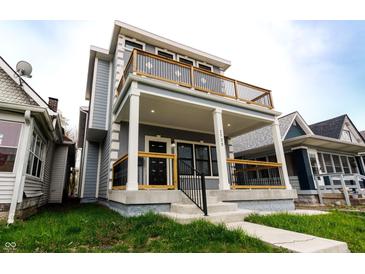 Charming two-story home with a covered porch and upper level balcony at 1723 Fletcher Ave, Indianapolis, IN 46203