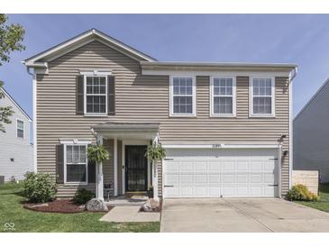 Charming two-story home featuring a well-maintained lawn and a two-car garage at 3189 Underwood Dr, Whiteland, IN 46184