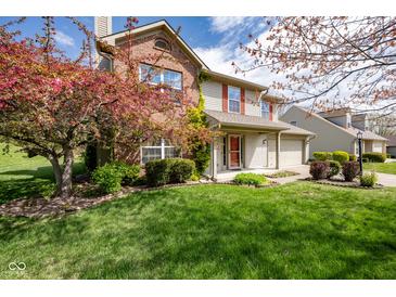 Charming two-story home with brick accents, flowering tree, and well-manicured lawn at 3611 Owster Ln, Indianapolis, IN 46237