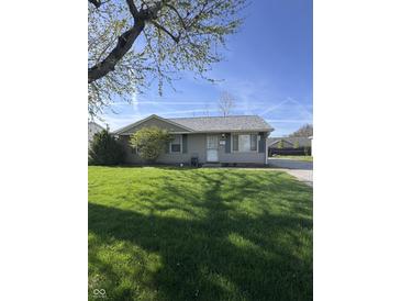 Charming single-story home with a well-maintained lawn and beautiful landscaping at 369 Northfield Dr, Mooresville, IN 46158