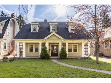 Charming home featuring lovely landscaping and inviting front porch area at 4247 Central Ave, Indianapolis, IN 46205