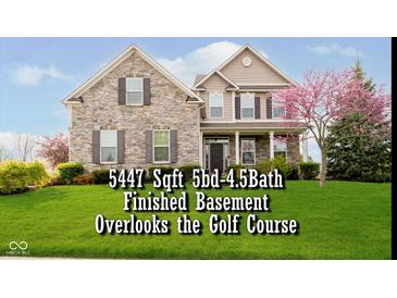 Charming two-story home with a stone facade, manicured lawn, and a beautiful flowering tree at 5196 E County Road 100 S, Avon, IN 46123