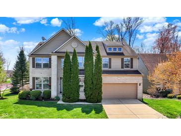 Charming two-story home with a well-manicured lawn and a two-car garage at 5549 Dill Ct, Indianapolis, IN 46237
