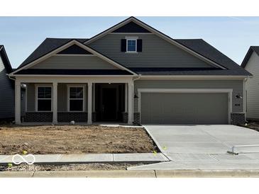 Charming single-Gathering home featuring a two-car garage, covered entryway, and pleasant neutral color scheme at 5661 Stetson Dr, Whitestown, IN 46052
