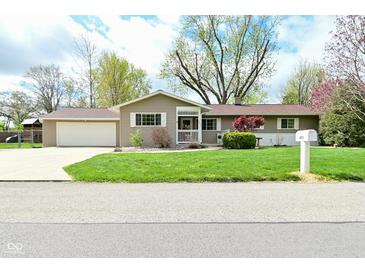 Charming single-story home with a well-manicured lawn and an attached two-car garage in a quiet neighborhood at 601 E 95Th St, Indianapolis, IN 46240